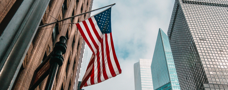 American flag on wall street representing US markets